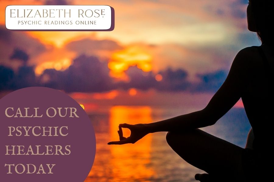 A silhouette of a woman meditating in the sunset representing psychic healing