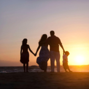 Family1 a family holding hands on the beach in the sunset