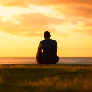 a silhouette of a man in the sunset