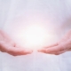 a healing psychic readers hands holding an aura