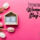 A pink background with flowers celebrating International Women's Day